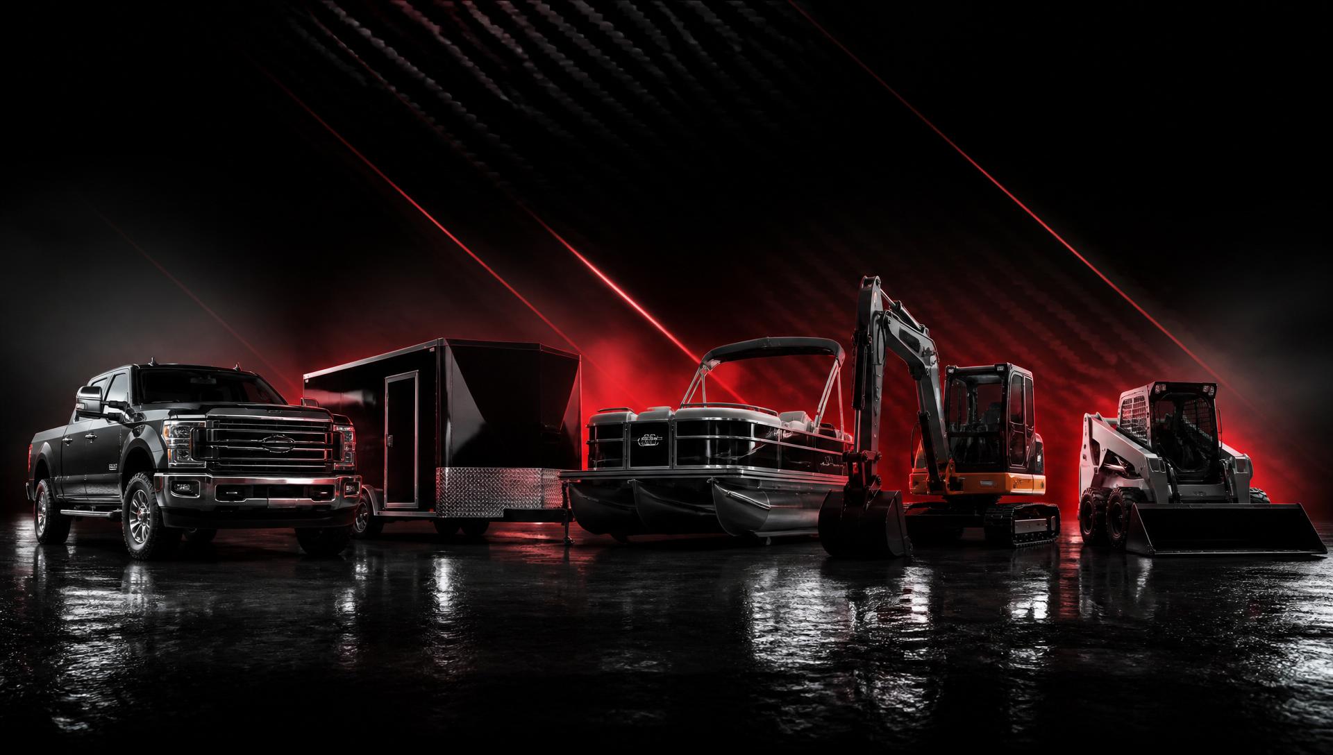 Lineup of trucks, trailers, boats and heavy equipment